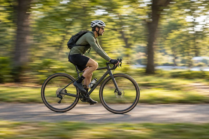 Generated panning illustration of a helmeted cyclist on a park path against horizontally streaked trees.