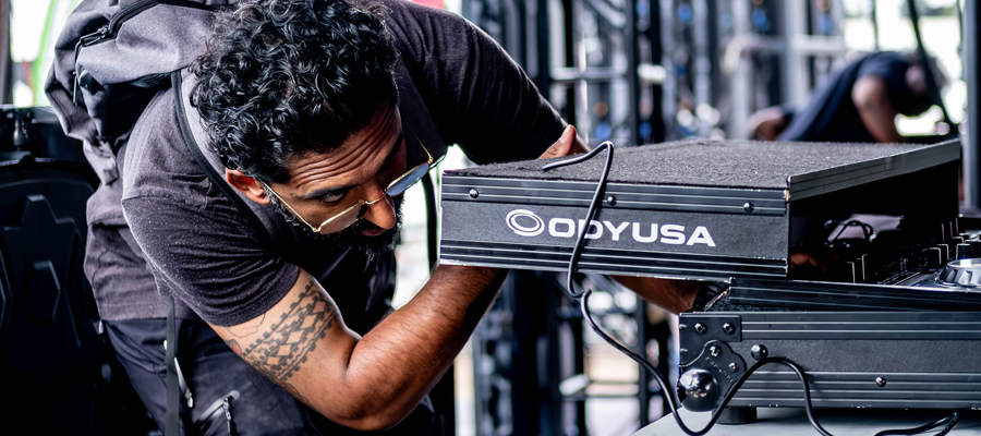 Setting the Stage Close up of a creative director inspecting an Odyssey DJ road case before a live event.